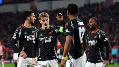 Arsenal's Martin Odegaard celebrates scoring their sixth goal with teammates. Reuters