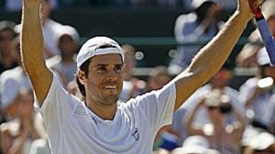 Tommy Haas raises his arms in delight after beating No 4 seed Novak Djokovic in the quarter-finals at SW19.