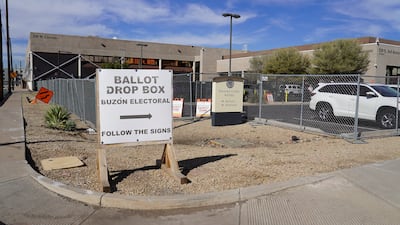 A sign directs voters to drop box location in downtown Phoenix. Willy Lowry / The National