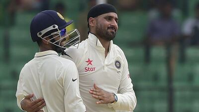 India's Harbhajan Singh celebrates taking the wicket of Bangladesh's Mominul Haque on Saturday during Day 4 of the one-off Test. Munir uz Zaman / AFP / June 13, 2015