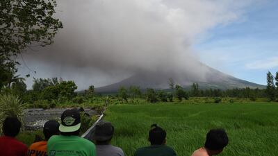 Residents watch as Mayon volcano spews ash at a tourist spot near Cagsawa ruins in Daraga in Albay province, south of Manila. Ted Aljibe / AFP Photo
