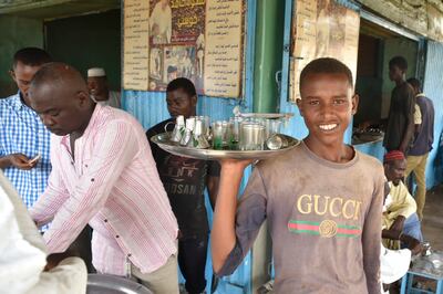 A boy serves customers at Hamed coffee shop in Kosti town, in Sudan's White Nile State, south of Khartoum. AFP