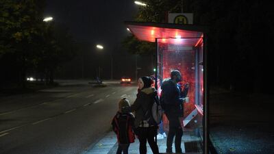 Wael, right, looks at the departure times of the bus he and his family will take to the register office in early morning before leaving the community centre of the Kreuzkirche where he lives with his wife and son in Hamburg, Germany. Reem, 30, and son Ali, 6, were reunited three weeks ago with the father of the family after they made it to Germany following an arduous journey. Astrid Riecken / Getty Images
