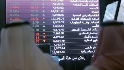 Saudi investors monitor stocks at the newly opened exchange market department at the National Commercial Bank (NCB) in Riyadh on November 12, 2014. NCB shares surged 10 per cent in their first day of trading after the kingdom’s largest public offering. It raised $6 billion and was oversubscribed 23 times. AFP PHOTO/FAYEZ NURELDINE