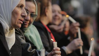 Egyptian Muslim women lights candles during a vigil at St Mark's Cathedral in Cairo for Christians who were killed in Libya by ISIL. Amr NabilAP Photo/AP Photo