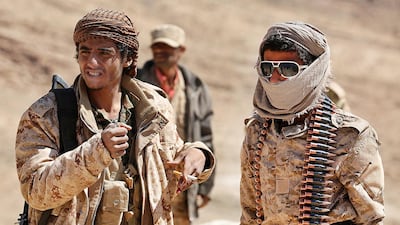 Yemeni tribesmen from the Popular Resistance Committees, who support forces loyal to the Saudi-backed Yemen president, rest as they guard a post in the battle against the Houthis. Abdullah Al Qadry / AFP
