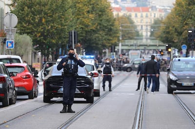 French policemen stand guard after a knife attack in Nice. AFP