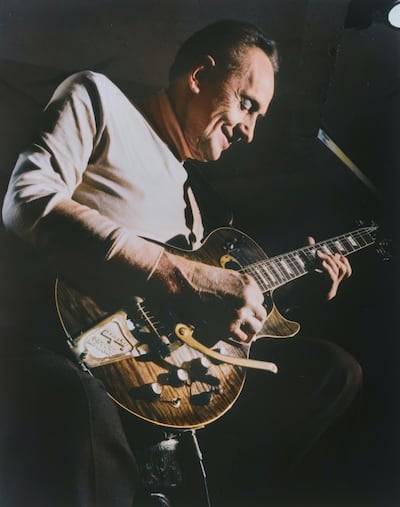 Guitar legend Les Paul with the guitar that bears his name at Fat Tuesday, New York in the 1980s. Getty