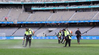 PERTH, AUSTRALIA - JULY 23: Ground staff attempt to dry the water logged pitch before the Pre-Season Friendly match between Manchester United and Aston Villa at Optus Stadium on July 23, 2022 in Perth, Australia. (Photo by Will Russell / Getty Images)