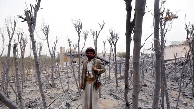 An armed tribesman loyal to Houthi militia inspects a destroyed house of a Yemeni army commander after it was allegedly hit by airstrikes carried out by the Saudi-led coalition in Hamdan district on June 9, 2015. According to local reports, airstrikes by the coalition targeted the Houthi-held defence ministry and a house of a Yemeni army commander allied with the Houthi militia. Yahya Arhab/EPA