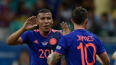 Colombia's Roger Martinez celebrates with teammate James Rodriguez. AFP