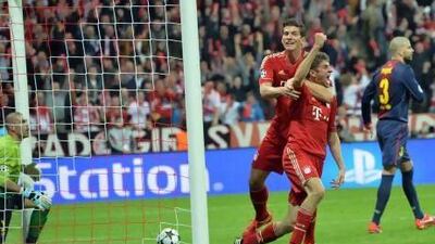 Bayern's Thomas Mueller, second right, celebrates with teammate Mario Gomez after scoring during the Champions League semifinal first leg soccer match between Bayern Munich and FC Barcelona on Tuesday. Kerstin Joensson / AP Photo