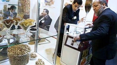 The Iranian pavilion at Gulfood has increased from 33 companies last year to 46 this year. Above, from left to right, marketing manager for Iran Sambol International, Reza Bahraini, speaks with food trader Ashrafe Youssef Abbas at Gulfood. Sarah Dea / The National