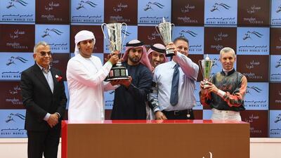 Patrick Dobbs, right, celebrates after riding Second Summer to victory in the Godolphin Mile. Martin Dokoupil / Getty Images