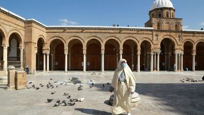 A Tunisian woman walks in the court of Al-Zaytuna mosque, the oldest in Tunis. AFP