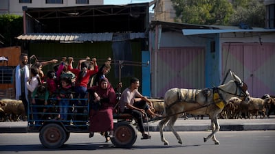 Palestinians flee to the southern Gaza Strip on Salah al-Din Street in Bureij. AP