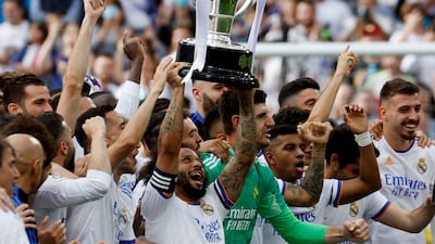 Real Madrid's Marcelo holds the trophy. Reuters
