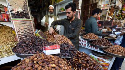 Pakistani vendors sell dates at their shops in Peshawar ahead of the start of the holy fasting month of Ramadan. AFP