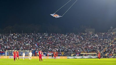 A flag supporting the ethnic Albanian diaspora flies over the pitch at FK Partizan Stadium in Belgrade on Tuesday night during the Euro 2016 qualifying match between Serbia and Albania. The stunt sparked chaos inside the stadium. Srdjan Suki / EPA