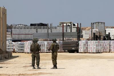 Israeli soldiers stand guard in Beit Hanoun, in the northern Gaza Strip, during an operation to deliver humanitarian aid from Jordan on Wednesday. AFP
