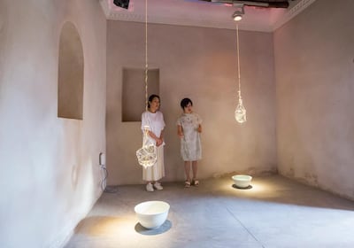 Curator Yuko Hasegawa and artist Tomoko Sauvage beside the In Curved Water installation at Bait Al Shamsi, Sharjah. Leslie Pableo / The National