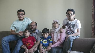 Feda and Aiman Awad, with their children (from left) Omar, 16, Hamza, 7, Malek, 10, and Ahmad 13, are weeks away from becoming homeless. Mona Al Marzooqi / The National