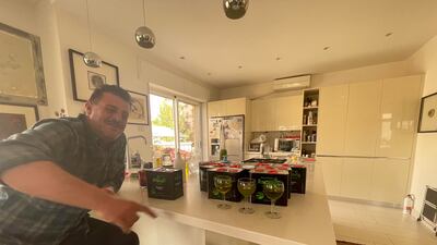Jordanian farmer Youssef Zubi examining the olive oil, a product of groves he is in charge of. Khaled Yacoub Oweis / The National
