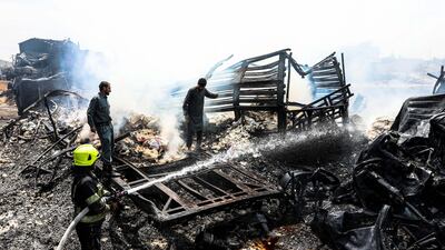 Firefighters work to extinguish burning fuel tankers a day after dozens of logistic trucks, mostly petrol tankers, have burned in flames in the outskirt of Kabul. EPA