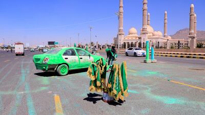 A Yemeni man spray paints a truck green, a color that holds religious significance in Islam, in front of Al-Saleh mosque in the capital Sanaa in response to comments by French President Emmanuel Macron defending cartoons of the Prophet Mohammed. AFP