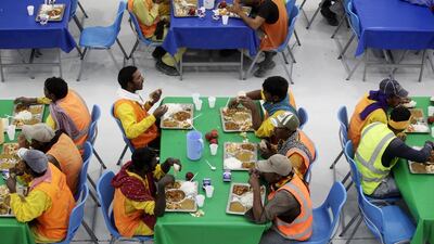 Workers have lunch during their mid-shift break. Christopher Pike / The National