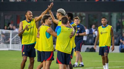 Pierre Emerick Aubameyang celebrates with Ronald Araujo during Barcelona's open training session at the DRV PNK Stadium. EPA