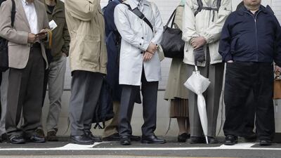 Shareholders wait in line to enter the venue of a Nissan extraordinary shareholders' meeting in Tokyo on Monday, April 8. They voted to remove him from the board following his arrest on alleged financial crimes. Bloomberg