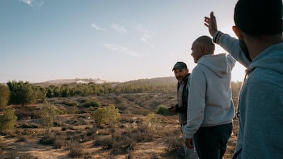 Residents of Agareb look on as trucks bring rubbish to the landfill. Photo: Erin Clare Brown / The National