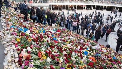 People place flowers on the steps at Sergels Torg plaza in Stockholm close to the point where a truck drove into a department store in Stockholm, Sweden on April 9, 2017. Four people died and fifteen were injured when a truck plunged into a crowd at a busy pedestrian street in the Swedish capital two days earlier. Jessica Gow/AFP / TT news agency
