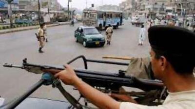 Paramilitary soldiers stop a car to be searched at a temporary checkpoint in Karachi yesterday.