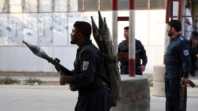 Afghan security personnel stand guard at the site of a deadly attack in Kabul, Afghanistan. Afghan officials say the political offices of the president's running mate were hit by a large explosion and stormed by an unknown number of attackers. Nasrat Rahimi, the interior ministry spokesman, said vice-presidential candidate and former intelligence chief Amrullah Saleh survived the attack. AP