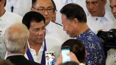 Philippine president Rodrigo Duterte (L) – pictured here with Chinese ambassador to the Philippines Zhao Jianhua (R) on August 17, 2016 – denies being a drug addict. Noel Celis/Pool/File Photo/Reuters