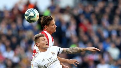 Marcos Llorente of Atletico Madrid wins a header over Toni Kroos of Real Madrid on Saturday. Getty Images
