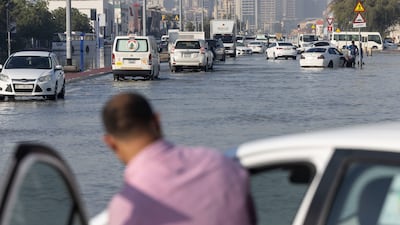 Many drivers had no choice but to abandon their waterlogged vehicles and take their chances on foot due to the record rainfall. Antonie Robertson / The National