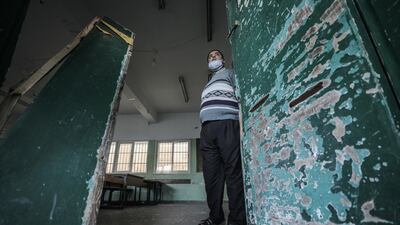 Palestinian inspects a damaged school near a street that Israel reportedly attacked after Palestinian militants fired rockets at Israel, in the east of Gaza city. EPA