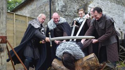 Lead Game of Thrones tour instructor William Kells ‘beheads’ a tourist as part of the Winterfell experience at Castle Ward. Charles McQuillan / Getty Images