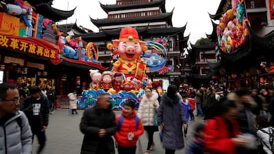 People walk by a giant decoration at Yu Yuan Garden in Shanghai, China. Reuters