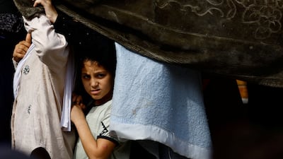 Palestinians queue to buy bread from a bakery, amid shortages of food supplies and fuel, in Khan Younis in the southern Gaza Strip, on October 22. Reuters