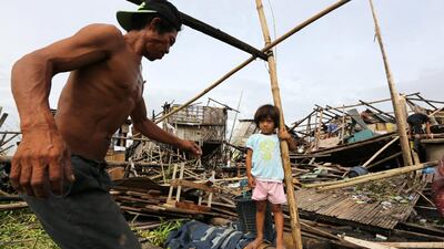 Filipino residents re-build destroyed homes in the city of Muntinlupa, south of Manila, Philippines on 17 July 2014. The strongest storm to hit the Philippines this year, Typhoon Rammasun, killed 38 people and left nearly 2 million in the capital and eastern provinces without power for a second day. Francis R Malasig/ EPA