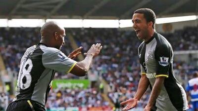 Tottenham Hotspur's Jermaine Defoe, left, celebrates his goal against Reading with Aaron Lennon during their Premier League soccer match at Madejski Stadium in Reading.