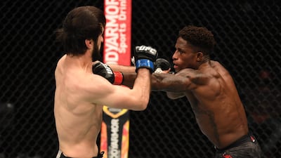 Hakeem Dawodu punches Zubaira Tukhugov in their featherweight bout during UFC 253 in Abu Dhabi. Josh Hedges / Zuffa LLC