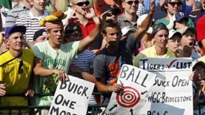 Fans' signs show their feelings as they cheer for Tiger Woods in the last Buick Open golf tournament to be held in Michigan.