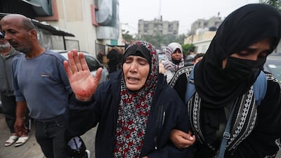 A woman reacts after the bodies of Palestinians killed during Israeli strikes on Ma'an school, east of Khan Younis, were laid out at Nasser Hospital. Reuters