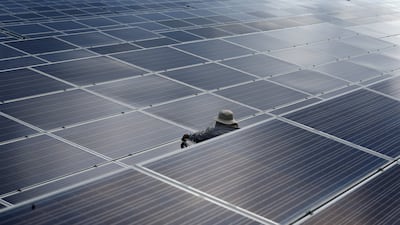 A worker at a solar power plant. Acwa Power's listing will be one of the biggest in the region's energy industry after Saudi Aramco, the kingdom's oil company. Reuters