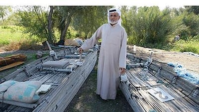 Abdullah Mohammed, a boat builder, with the shashas at his farm in Al Owaid.